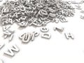 Jumbled pile of 3D illustrated white uppercase letters over a white background H