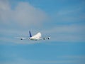 Jumbo airplane is taking off into a blue sky