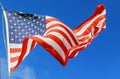 Jumbo beautiful American flag on a flying against a sky Royalty Free Stock Photo