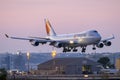 Jumbo Jet landing in low light after sunset Royalty Free Stock Photo