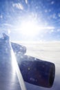 Jumbo Jet wing over clouds backlit by amazing sunset Royalty Free Stock Photo