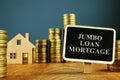 Jumbo Loan mortgage inscription and stacks of coins Royalty Free Stock Photo