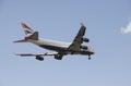 Jumbo 747 passenger jet with landing gear down Royalty Free Stock Photo