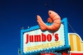 A jumbo shrimp hangs from a dinerÃ¢â¬â¢s sign Royalty Free Stock Photo