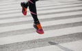 Jump and freeze in air. Girl in sportswear and sneakers runs along transition along the road