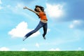 Jump girl over a grass Royalty Free Stock Photo