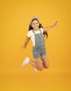 Jump of happiness. small girl jump yellow background. full of energy. Active girl feel freedom. Fun and relax. feeling