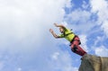 Jump rope from a high rock in the mountains. Royalty Free Stock Photo