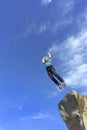 Jump rope from a high rock in the mountains. Royalty Free Stock Photo