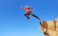 Jump rope from a high rock in the mountains Royalty Free Stock Photo