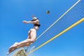 Jump of young girl, playing volleyball on beach. concept of healthy lifestyle. Blocking the ball. Royalty Free Stock Photo