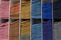 Jumper made of natural fabric, rolled up and neatly stowed in the closet. Knitwear clothing shelf assortment, photography