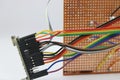 Jumper wires or rainbow color wires are making connections between a zero printed circuit board and microcontroller