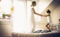Jumping on bed is fun. Little girl with her mother. Royalty Free Stock Photo