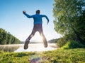 Jumping boy celebrate freedom and make fun at lake Royalty Free Stock Photo