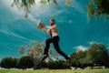 Jumping business man with laptop outdoor in park. Concept of fast internet with running businessman with a laptop. Royalty Free Stock Photo