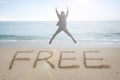 Jumping businessman cheering with free word handwritten in sand Royalty Free Stock Photo