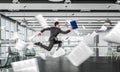 Jumping businessman in office . Mixed media Royalty Free Stock Photo