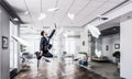 Jumping businessman in office . Mixed media Royalty Free Stock Photo