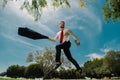 Jumping businessman in park. Fast business concept. Royalty Free Stock Photo
