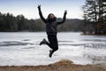 Jumping Chinese woman on beach winter Royalty Free Stock Photo