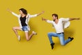 Jumping Couple, Full Length Profile Young People in Dance, Isolated Yellow Background