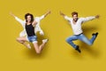 Jumping Couple, Full Length Young Happy People in Sport Dance, Isolated Yellow Background