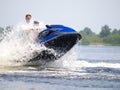 Jumping couple men on jet ski