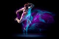 One energy young flexible sportive man dancing hip-hop or breakdance in white outfit on dark background in mixed blue