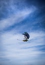 Jumping freestyle skier on blue sky background. Royalty Free Stock Photo