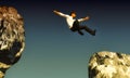 Jumping a gap between two rocks Royalty Free Stock Photo