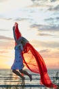 Jumping girl with red cloth Royalty Free Stock Photo