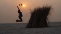 Jumping Girl with sand on Sunshade