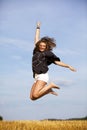 Jumping happy blond teenage girl Royalty Free Stock Photo