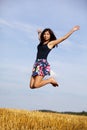 Jumping happy brunette teenage girl Royalty Free Stock Photo