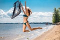 Jumping happy girl on the beach, fit sporty healthy body in bikini Royalty Free Stock Photo