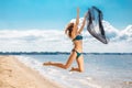 Jumping happy girl on the beach, fit sporty healthy body in bikini