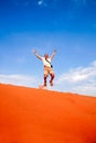 Jumping high on the sand dunes Royalty Free Stock Photo