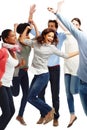 Jumping for joy. Group of casually dressed young adults jumping excitedly against a white background. Royalty Free Stock Photo