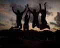 Jumping for joy. Shot of a group of jumping friends silhouetted against a sunset. Royalty Free Stock Photo