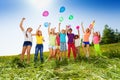 Jumping kids with flying balloons in summer Royalty Free Stock Photo