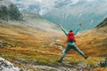 Jumping Man with backpack hands raised mountains landscape Royalty Free Stock Photo