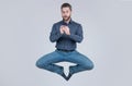 jumping man businessman chatting online on smartphone and meditating in yoga pose, business yoga.