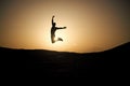 Jumping man silhouette at sunset sky Royalty Free Stock Photo