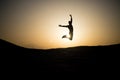 Jumping man silhouette at sunset sky Royalty Free Stock Photo