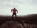 Jumping man. Young crazy man is jumping on rocky summit above landscape. Silhouette of jumping man Royalty Free Stock Photo