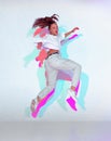 Jumping mixed race young girl dance in colourful light. Female dancer performer jump dancing fiery hip hop Royalty Free Stock Photo