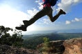 Jumping over precipice between two rocky mountains . freedom Royalty Free Stock Photo