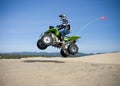 Jumping quad in dunes Royalty Free Stock Photo