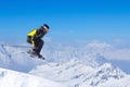 Jumping skier at mountains